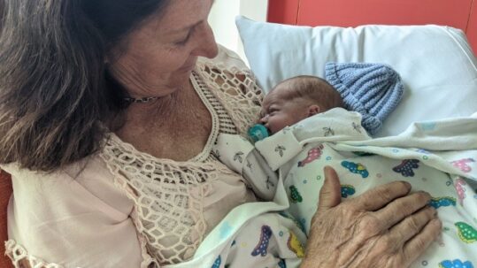 Annette holding her grandson Hugo