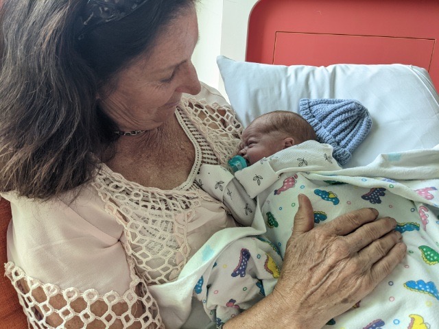 Annette holding her grandson Hugo