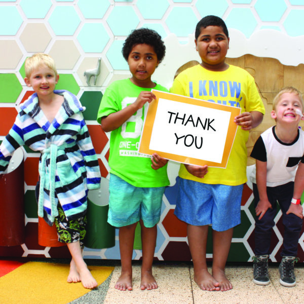 Photo of children holding up a sign saying Thank You